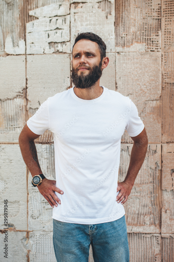Handsome hipster man with beard wearing white blank t-shirt with space for your logo or design. white t shirt mockup. Handsome hipster man with beard wearing white blank t-shirt with space for your logo or design. white t shirt mockup.