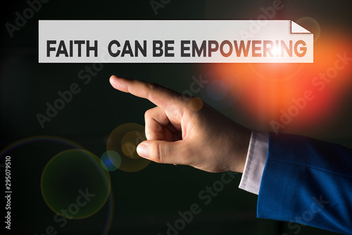 Writing note showing Faith Can Be Empowering. Business concept for Trust and Believing in ourselves that we can do it Isolated hand pointing with finger. Business concept pointing finger
