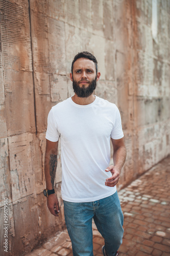 Handsome hipster man with beard wearing white blank t-shirt with space for your logo or design. white t shirt mockup.