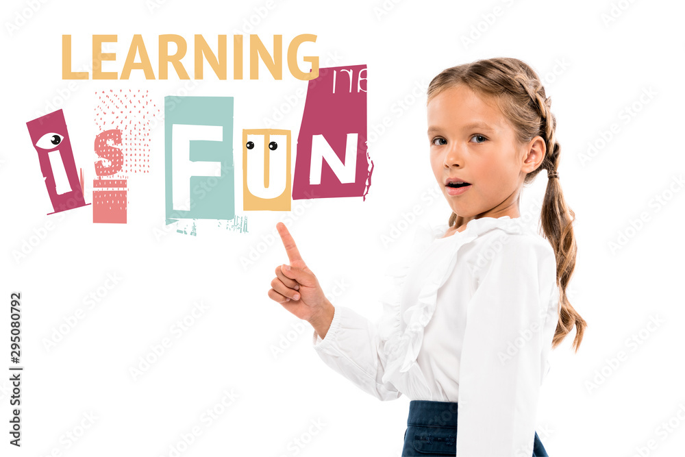 adorable kid pointing with finger at learning is fun lettering on white adorable kid pointing with finger at learning is fun lettering on white