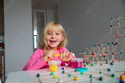 cute girl making geometric shapes from clay, engineering and STEM