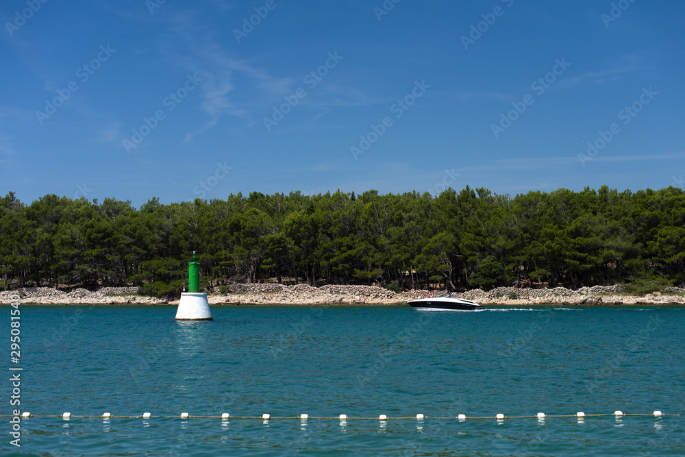 Obraz premium Big buoy in the lake and the boat