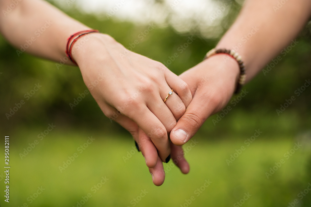 young couple holding hands young couple holding hands