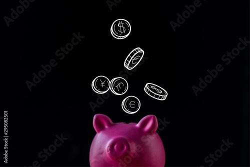 pink piggy bank near coins with dollar and euro signs on black