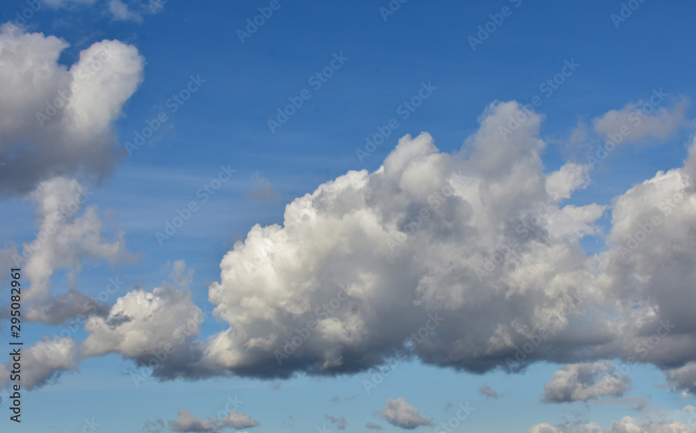 Beautiful flowing clouds in the blue sky on an autumn day. Beautiful flowing clouds in the blue sky on an autumn day.