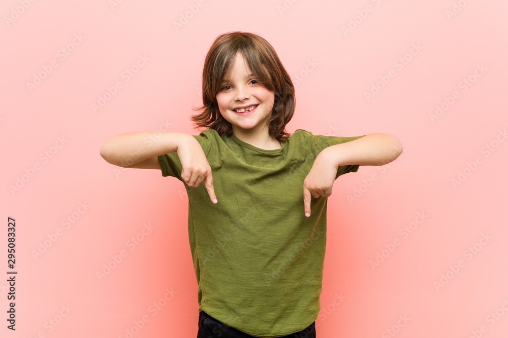 Little boy points down with fingers, positive feeling. Little boy points down with fingers, positive feeling.
