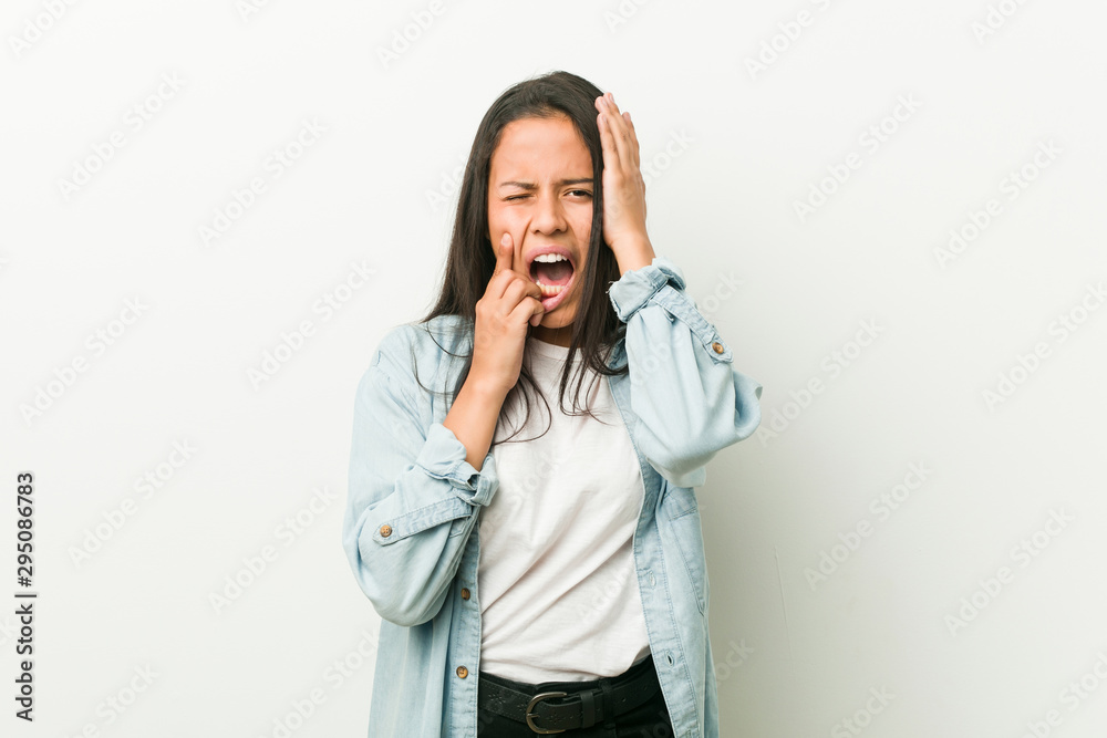 Young hispanic woman whining and crying disconsolately.