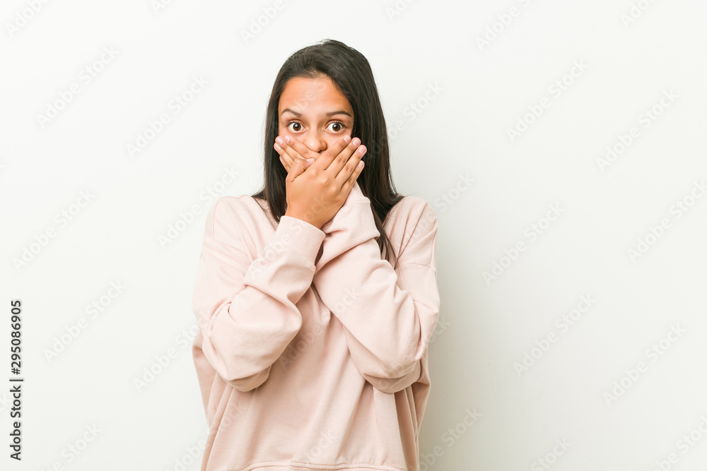 Young cute hispanic teenager woman shocked covering mouth with hands. Young cute hispanic teenager woman shocked covering mouth with hands.