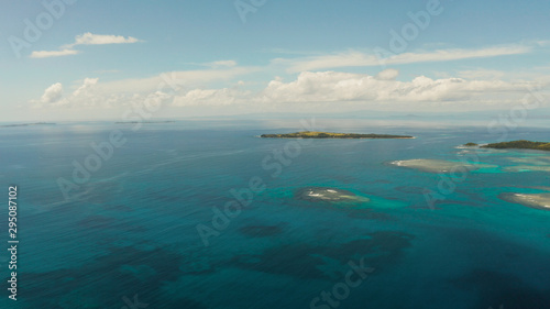 Tropical islands in turquoise lagoon and coral reef water, aerial view. Bucas grande, Philippines. Summer and travel vacation concept. photo