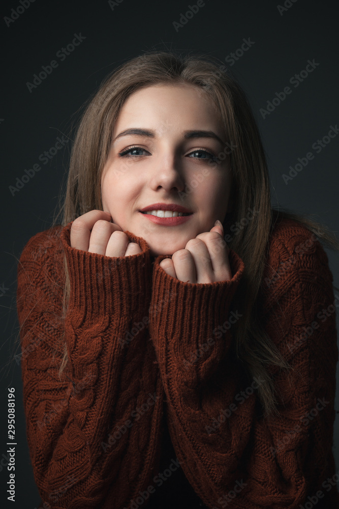 Portrait of gentle young woman in red sweater Portrait of gentle young woman in red sweater