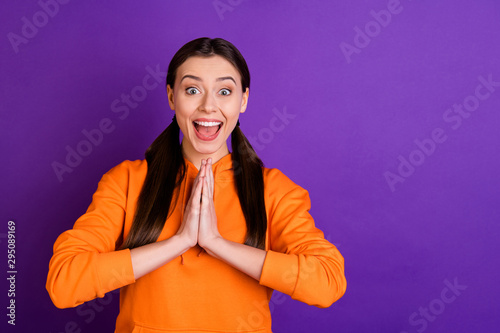 Portrait of impressed enthusiastic funky funny youth girl get present for holidays scream wow omg wear modern hood sweater sportive wear isolated over purple violet color background