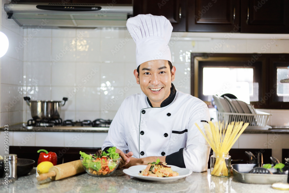 Asian Chef cooking in kitchen restaurant Asian Chef cooking in kitchen restaurant