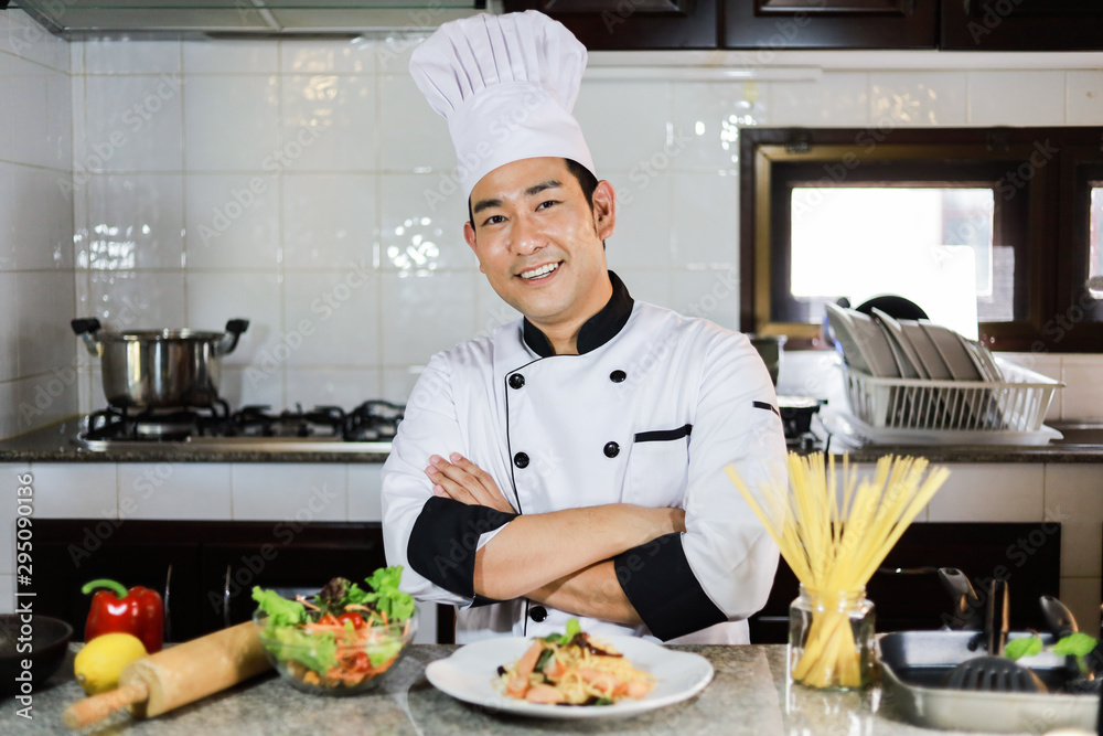 Asian Chef cooking in kitchen restaurant Asian Chef cooking in kitchen restaurant