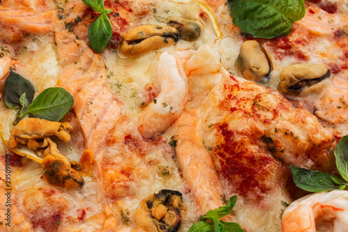 Seafood Italian pizza with shrimp,squid, mussels, fresh herbs and mozzarella on a crusty base viewed from above on Gray background. Horizontal photo.