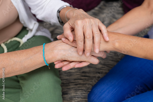 Senior mother and adult daughter giving support to each other. Closeup of senior and young woman holding hands. Mother and daughter Family affection concept