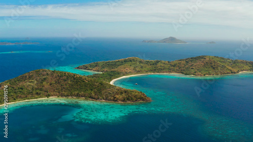 tropical island with blue lagoon, coral reef and sandy beach. Ditaytayan, Palawan, Philippines. Islands of the Malayan archipelago with turquoise lagoons.