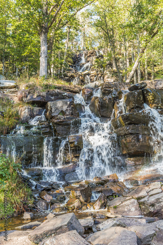 Ramhultavägen waterfall with moving water due to slow shutter speed lies in the river Ramnån and flows out into Lake Lygnern in the Västra Götaland region near the town of Sätila in Sweden photo