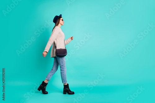 Full length body size view of her she nice-looking attractive lovely charming pretty cute fashionable girl walking isolated over bright vivid shine vibrant color turquoise green background