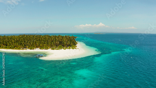 Tropical landscape: small island with beautiful beach, palm trees by turquoise water view from above. Patongong Island with sandy beach. Summer and travel vacation concept.
