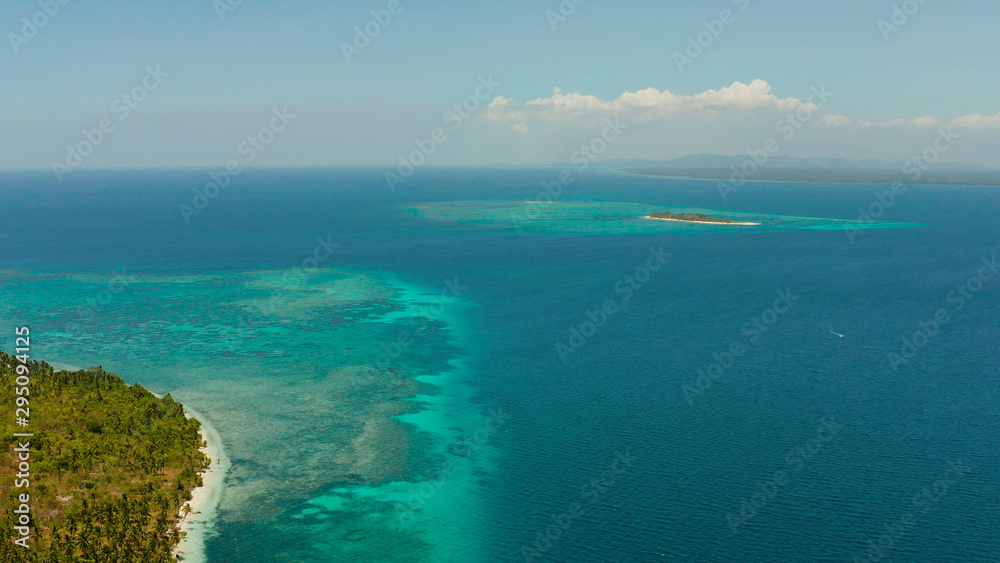 Sandy beach and tropical islands by atoll with coral reef, top view. Patongong Island with sandy beach. Summer and travel vacation concept.