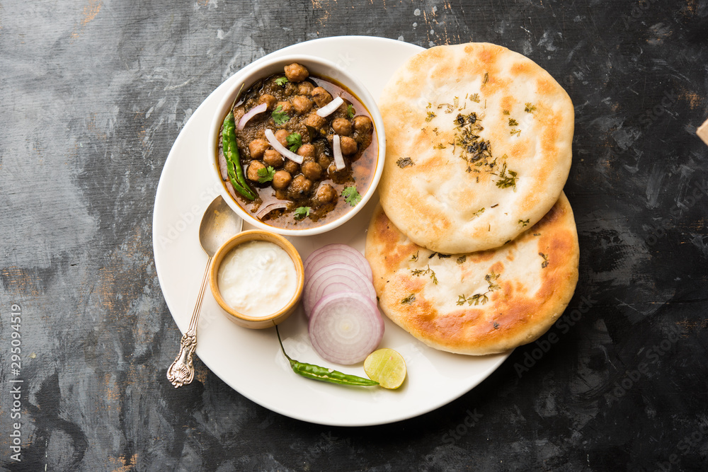 Pindi Chole Kulche or roadside choley Kulcha popular in India and pakistan is a popular streetfood. It's a spicy Chickpea or chana curry served with Indian Flat Bread. selective focus Pindi Chole Kulche or roadside choley Kulcha popular in India and pakistan is a popular streetfood. It's a spicy Chickpea or chana curry served with Indian Flat Bread. selective focus