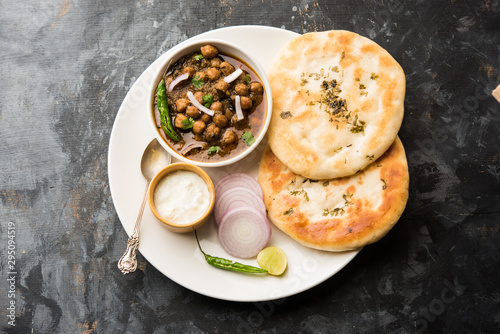 Pindi Chole Kulche or roadside choley Kulcha popular in India and pakistan is a popular streetfood. It's a spicy Chickpea or chana curry served with Indian Flat Bread. selective focus photo