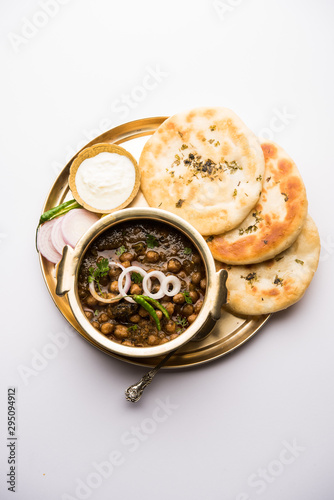 Pindi Chole Kulche or roadside choley Kulcha popular in India and pakistan is a popular streetfood. It's a spicy Chickpea or chana curry served with Indian Flat Bread. selective focus
