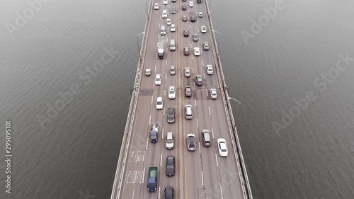 Busy traffic on Cheongdam Bridge, part of Seoul city Dongbu expressway, aerial shot. Many cars move in both directions, all six lanes of road filled up with motor vehicles photo