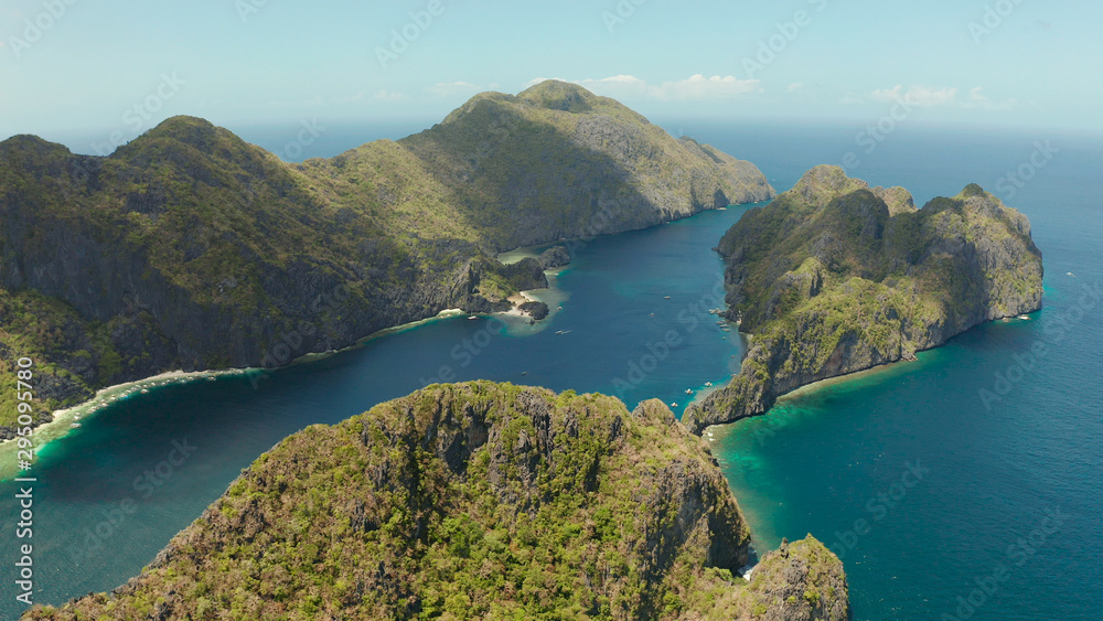 Seascape with tropical rocky islands, ocean blue water, aerial view . islands and mountains covered with tropical forest. El nido, Philippines, Palawan. Tropical Mountain Range