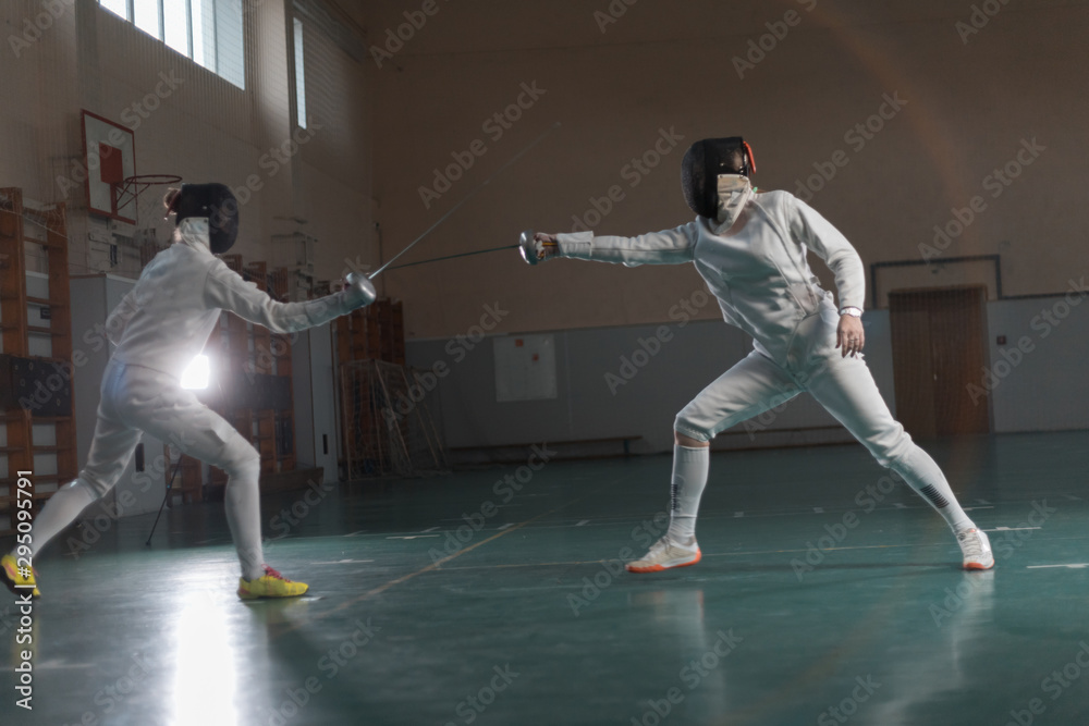 A portrait of two young women fighting with swords A portrait of two young women fighting with swords