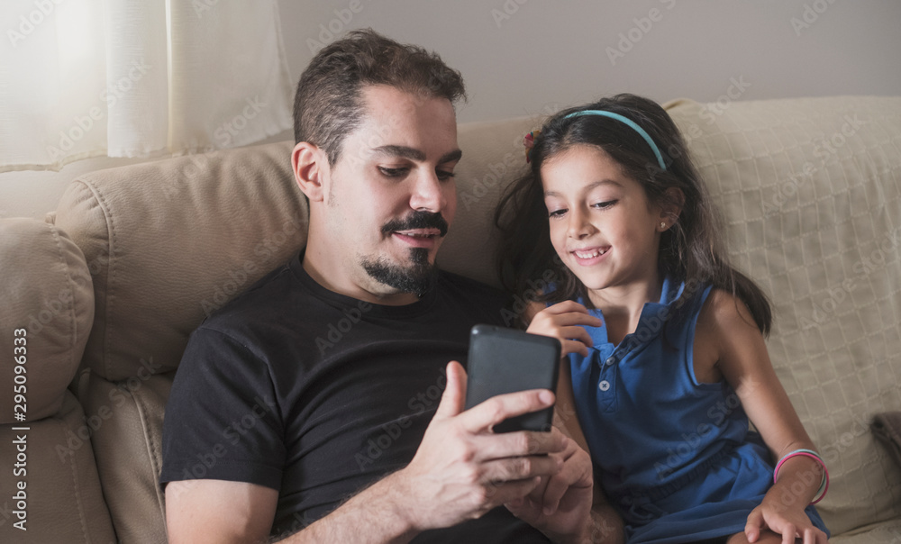 Father son and daughter at home looking smartphone Father son and daughter at home looking smartphone