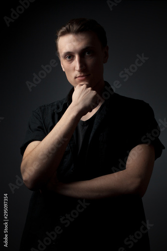 Portrait of serious young man on gray background