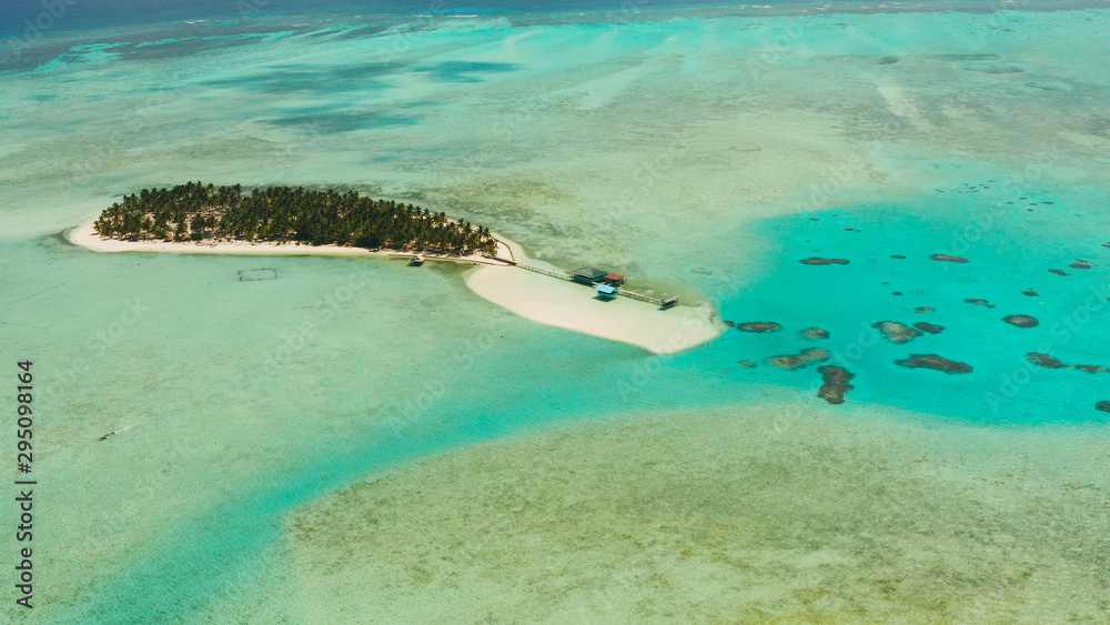 Tropical landscape: small island with beautiful beach, palm trees by turquoise water view from above. Onok Island, Balabac, Philippines. Summer and travel vacation concept