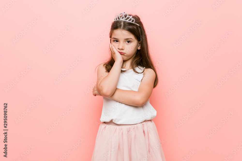 Little girl wearing a princess look who is bored, fatigued and need a relax day. Little girl wearing a princess look who is bored, fatigued and need a relax day.