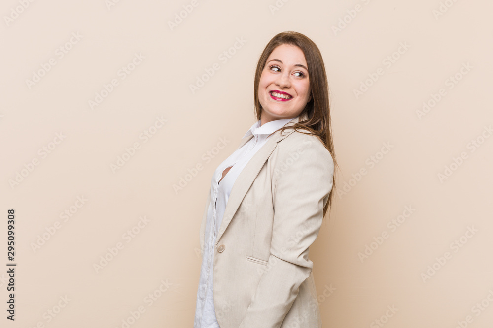 Young business woman looks aside smiling, cheerful and pleasant. Young business woman looks aside smiling, cheerful and pleasant.