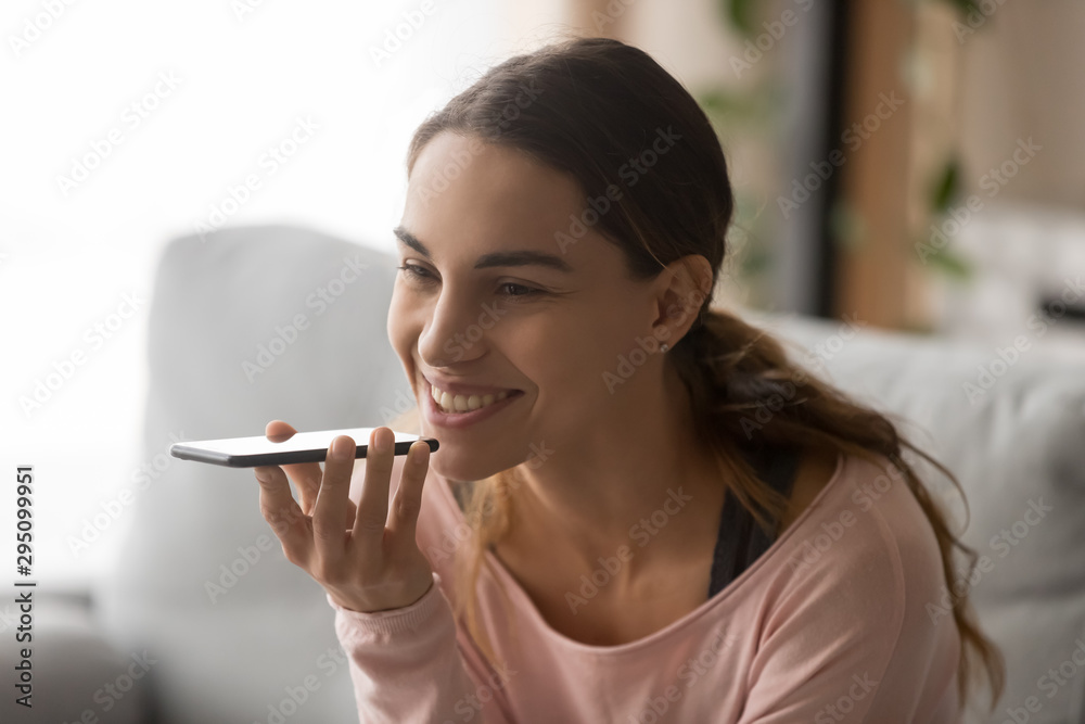 Smiling woman activate virtual digital voice assistant on mobile phone Smiling woman activate virtual digital voice assistant on mobile phone