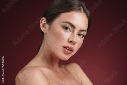 Image of shirtless young woman with clean fresh face looking at camera