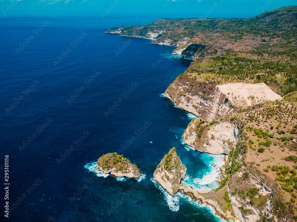 Coastline with cliff and blue ocean in Nusa Penida. Aerial drone view of island
