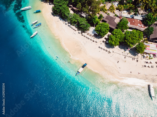 Tropical island with beach and turquoise transparent ocean, aerial view. Gili island