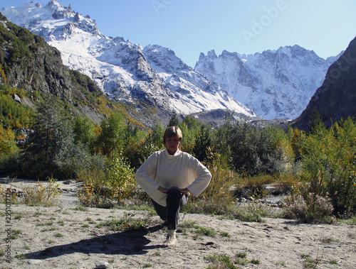 Woman practices yoga in a mountain gorge. Travel Lifestyle Relaxation. Emotional concept. Outdoor adventure. Harmony with nature.