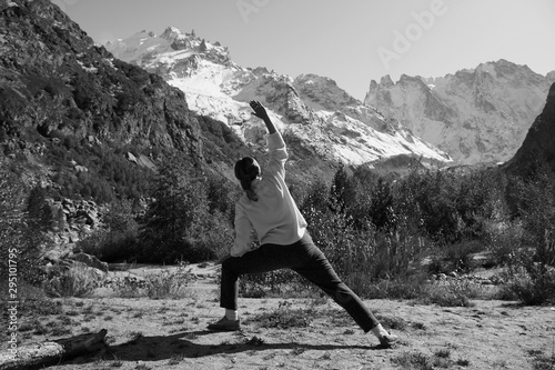 Woman practices yoga in a mountain gorge. Travel Lifestyle Relaxation. Emotional concept. Outdoor adventure. Harmony with nature.