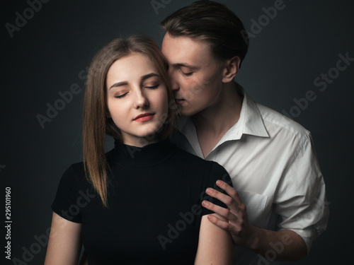 Young passionate couple in love posing in studio