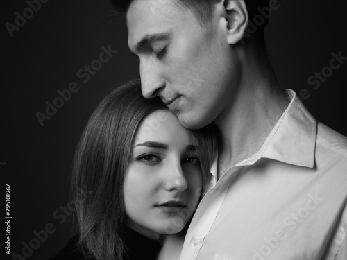 Portrait of young man and woman in studio. Couple in love. Black and white