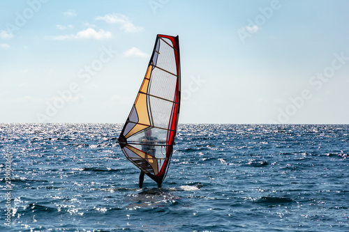 Beautiful view of windsurfer sailing on the waves. Windsurfing on the Black Sea. Yalta, Crimea. © MarinoDenisenko