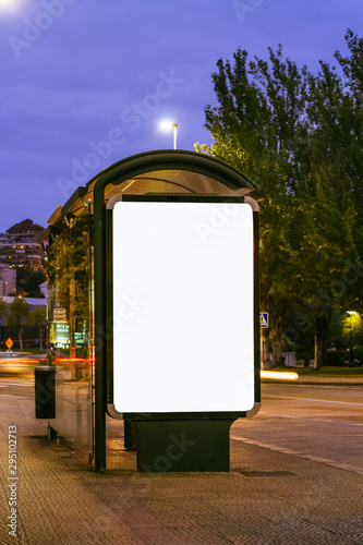 Blank mock up of vertical light box in bus stop at night