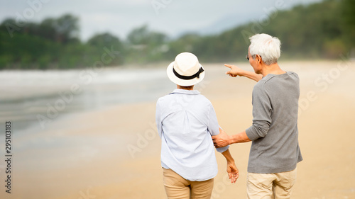 senior man and woman hugging while walking on the beach Retirement Lifestyle Healthy Travel Vacation Concept ,Banner for text