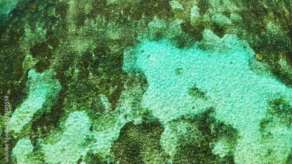 Turquoise lagoon surface on atoll and coral reef, copy space for text. Top view transparent turquoise ocean water surface. background texture