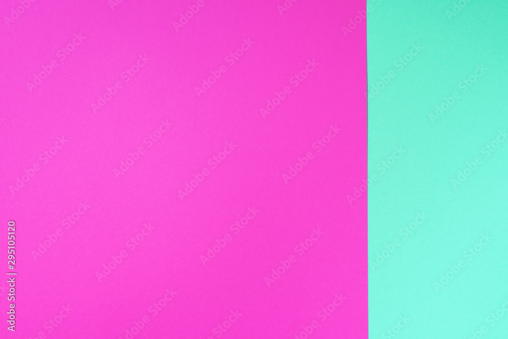 Fototapeta premium Colorful trendy green and pink paper background. Top view. Copy space
