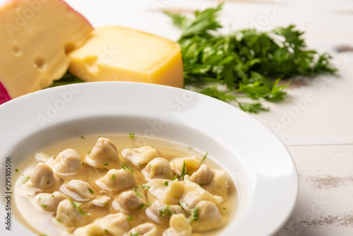 Fresh capeletti soup; Capeletti in brodo - Italian cuisine, soft light, copy space photo