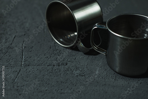 steel empty cups on a dark background